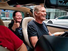 David Hasselhoff smiling behind the wheel of KITT in downtown Toronto